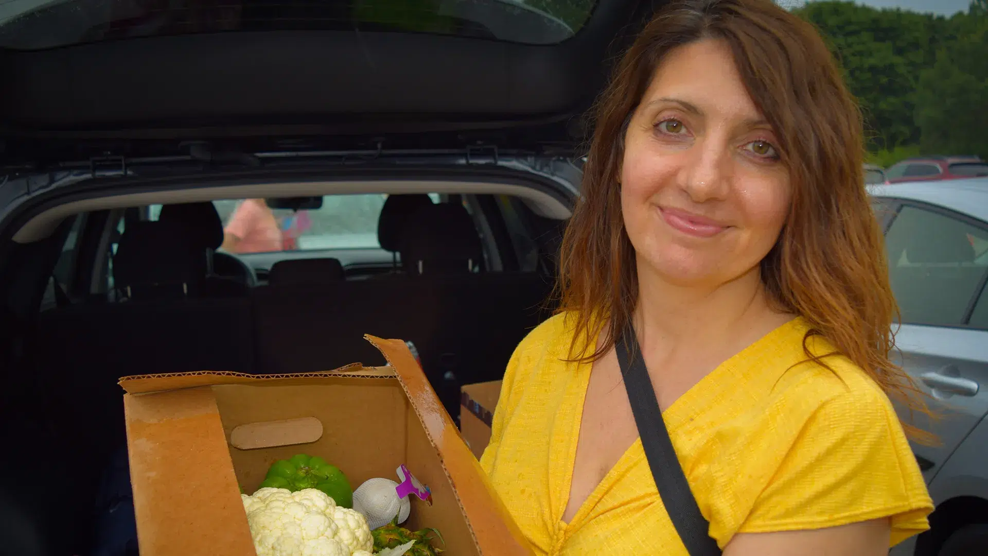 MPX customer holding box of groceries